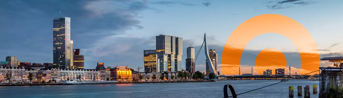 A cityscape of Rotterdam at sunset, featuring Erasmus Bridge and modern high-rise buildings. An orange circular graphic aka ORANJEGROEP logo is placed on the right side of the image imitating the sun.