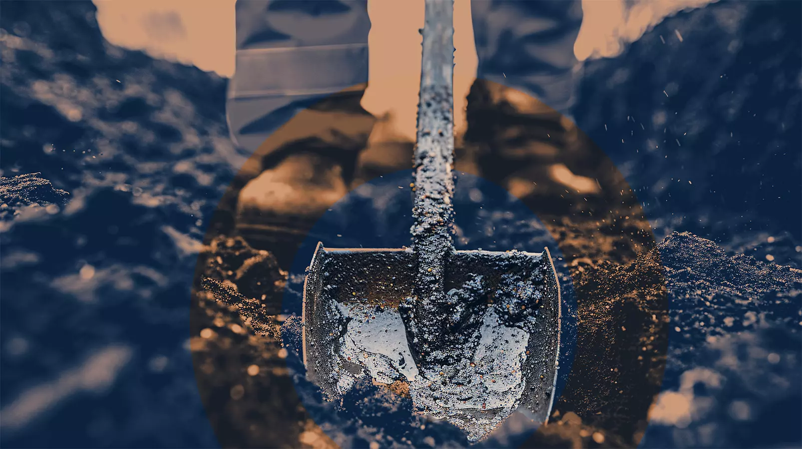Groundwork That Builds the Future Close-up of a shovel digging into soil with a worker standing behind, highlighting manual groundwork.